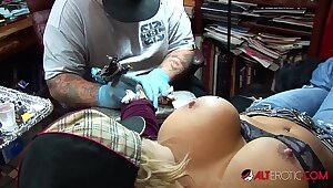 Shyla Stylez gets tattooed while playing upon her tits